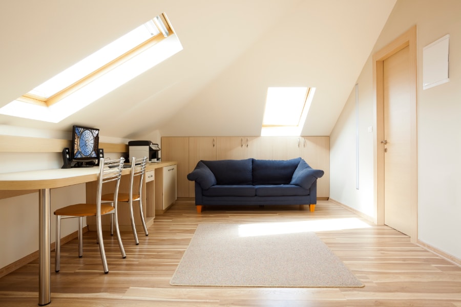 Light and airy velux loft conversion with long table and sofa