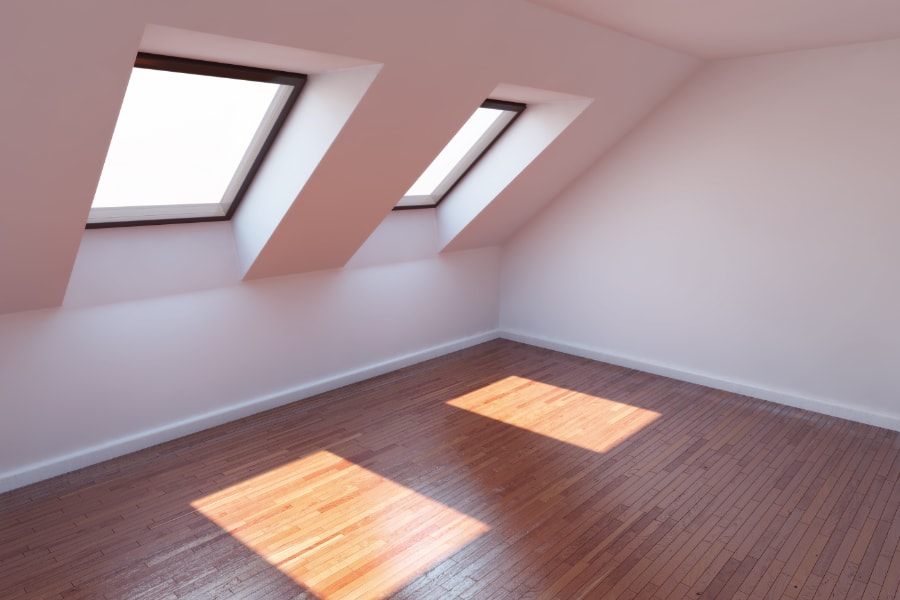 2 roof light velux windows in spacious loft conversion containing white walls and wooden flooring in Swansea